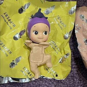 Purple and Tan Kids Doll with Playful Design